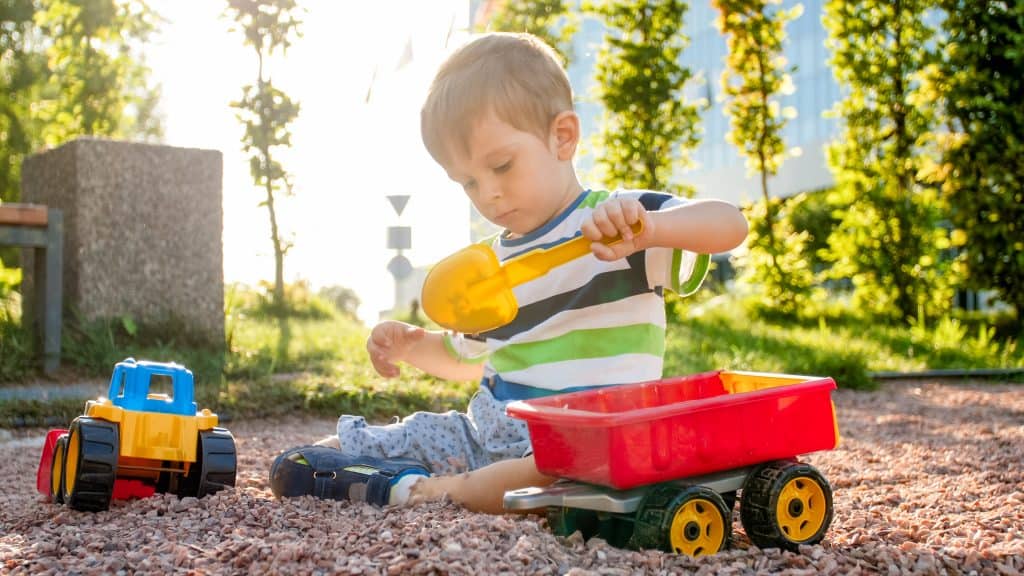photo-adorable-3-years-old-toddler-boy-playing-with-sand-you-truck-trailer-park-child-digging-building-sandpit