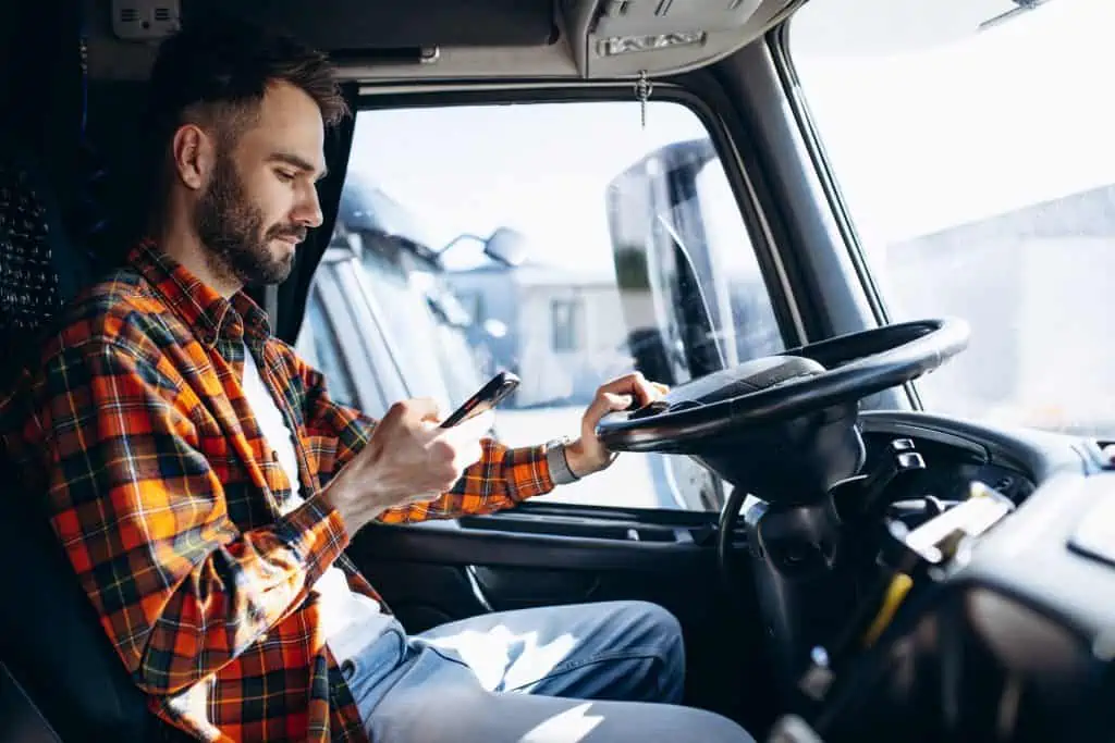 Trucker on his phone looking at social media